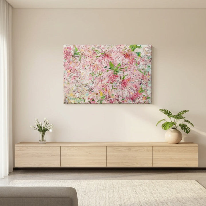 Floral painting on a wall above a wooden cabinet in a living room.